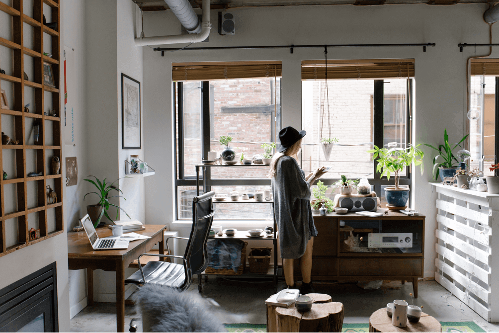 woman looking out of her apartment window