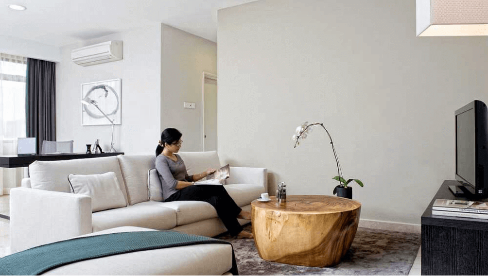 Guest Sitting In The Living Room Reading A Magazine